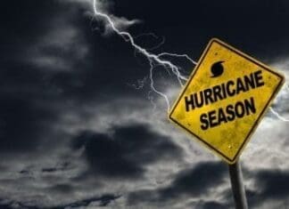Storm-Ready Starts with Coverage: What You Need to Know Before Hurricane Season Hurricane season with symbol sign against a stormy background and copy space. Dirty and angled sign adds to the drama.